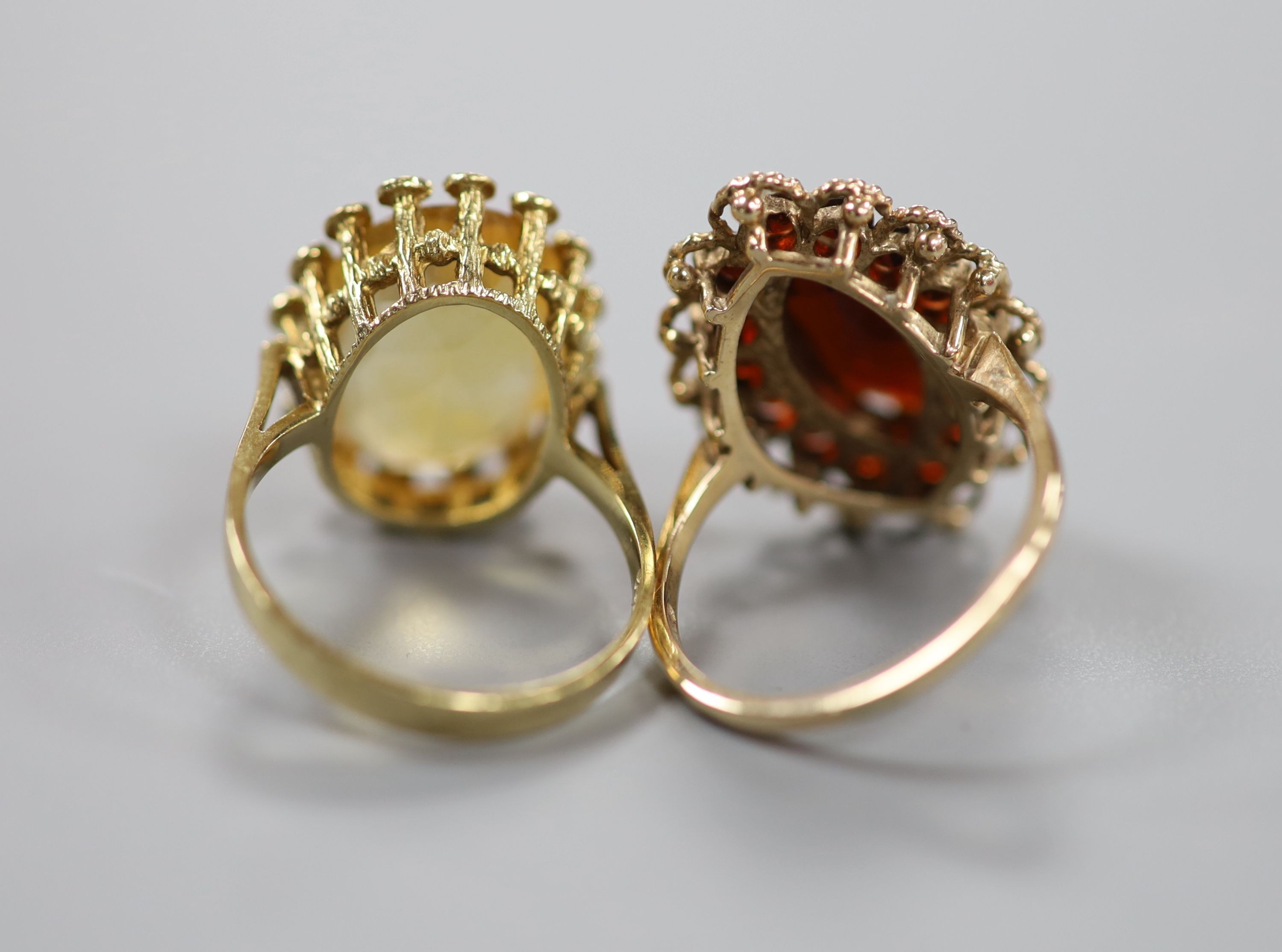 Three assorted 9ct gold and gem set rings including garnet and citrine, gross 11.4 grams, a yellow metal and turquoise ring, gross 1.4 grams and a white metal and diamond chip set full eternity ring, gross 2.2 grams.